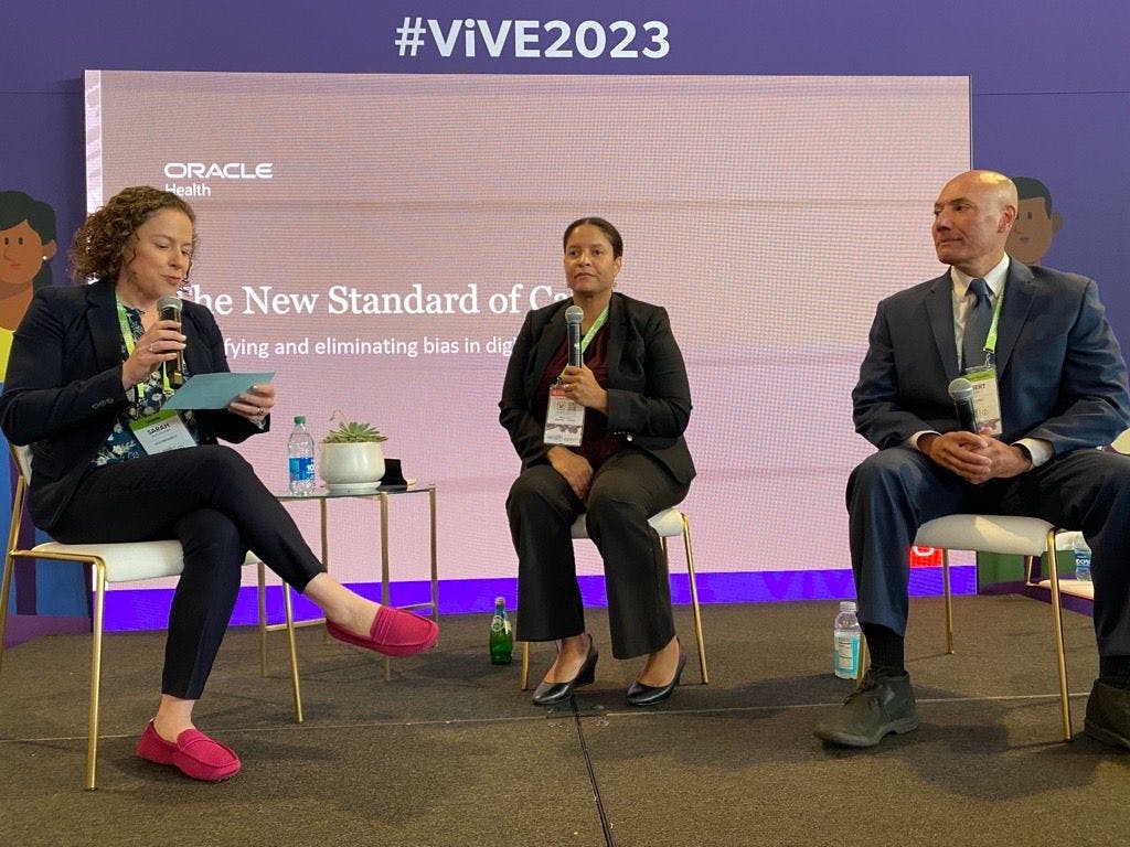 Sarah Matt, vice president of Oracle Health, left, talks with Brenda Ayers, medical director for health equity at Nuvance Health, and Albert Villarin, chief medical informatics officer at Nuvance Health, during the ViVE Conference in Nashville.